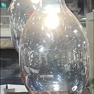 Two smoke grey and white glass pendants.